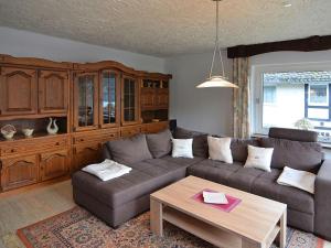 a living room with a couch and a table at Apartment in Assinghausen with a Sun Terrace in Assinghausen