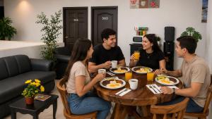 a group of people sitting around a table eating breakfast at hotel barmel in Siguatepeque