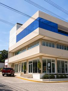a building with a truck parked in front of it at hotel barmel in Siguatepeque