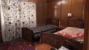 a bedroom with two beds and a table in a room at Houseboat Saleem in Dal Lake +5 photos