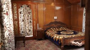 a bedroom with a bed and a wooden wall at Houseboat Saleem in Dal Lake