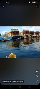 two boats are docked in the water on the water at Houseboat Saleem in Dal Lake
