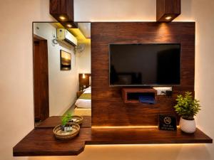 a living room with a flat screen tv on a wall at BEN-SEN Puri #Affordable # S-Pool in Puri +28 photos