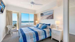 a bedroom with a bed and a large window at The Moorings Unit 508 in Golden Beach +7 photos