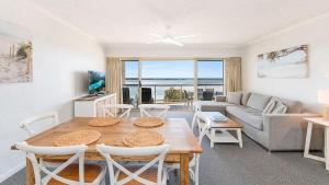a living room with a table and chairs and a couch at The Moorings Unit 508 in Golden Beach