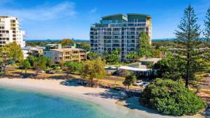 an aerial view of a resort with a beach and buildings at The Moorings Unit 508 in Golden Beach