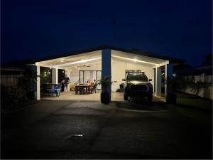 a car parked in front of a garage at night at Beachside Bliss In The Crown in Kawana Waters