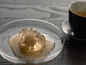 a piece of food on a glass plate next to a cup of coffee at KÚON Hakone Gora in Hakone +62 photos