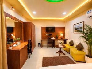 a living room with a yellow couch and a table at BEN-SEN Puri #Affordable # S-Pool in Puri