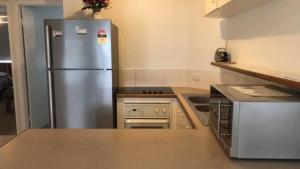 a kitchen with a stainless steel refrigerator at Windbourne Unit 8 in Golden Beach +5 photos