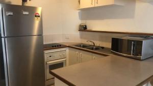 a kitchen with a stainless steel refrigerator and a sink at Windbourne Unit 8 in Golden Beach