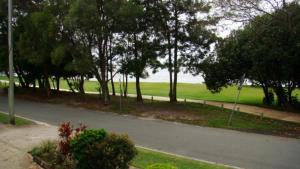 an empty road with trees on the side of a field at Windbourne Unit 8 in Golden Beach