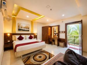 a large bedroom with a bed and a balcony at BEN-SEN Puri #Affordable # S-Pool in Puri