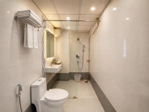 a white bathroom with a toilet and a shower at BEN-SEN Puri #Affordable # S-Pool in Puri