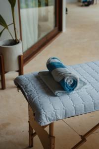 a rolled up towel sitting on top of a bench at SEACLUB Siargao in General Luna