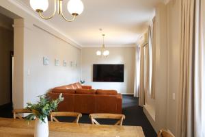 a living room with a couch and a table at Hotel Gosford in Gosford