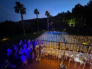 a group of people standing around a table with lights at Quinta Clara in Vila Verde +123 photos