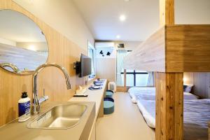 a bathroom with a sink and a bed in a room at DreamFriend新浦安 in Tokyo +116 photos