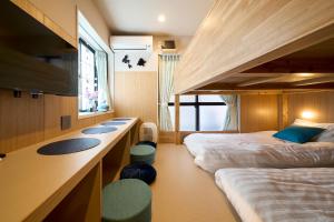 a hotel room with two beds and a desk and a bunk bed at DreamFriend新浦安 in Tokyo