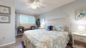 a bedroom with a bed and a ceiling fan at Summit 1013 in Panama City Beach