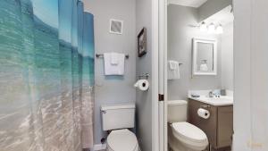 a bathroom with a toilet and a sink at Summit 1013 in Panama City Beach +30 photos