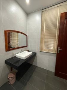a bathroom with a sink and a mirror at Home Me 2 in Dong Hoi +19 photos