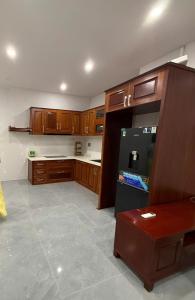 a large kitchen with wooden cabinets and a counter at Home Me 2 in Dong Hoi