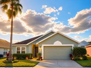 a house with a palm tree and a garage at Villa Brittany Private Pool • Close to Disney in Kissimmee