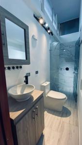 a bathroom with a sink and a toilet at Casa Largo Katayama in Ruiosucio +18 photos