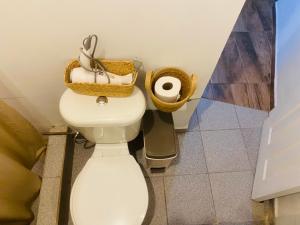 a bathroom with a toilet with baskets on top of it at Casa Ckunna in San Pedro de Atacama