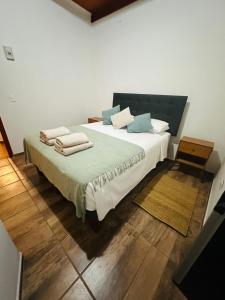 a bedroom with a large bed with towels on it at Casa Ckunna in San Pedro de Atacama +9 photos