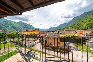 a balcony with chairs and a view of mountains at B&B La Vecchia Tipografia - Lago D'Idro in Ponte Caffaro