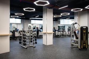 a gym with several rows of equipment and a suitcase at Khubilai Hotel Ulaanbaatar in Ulaanbaatar