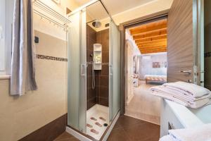 a bathroom with a shower and a glass door at B&B La Vecchia Tipografia - Lago D'Idro in Ponte Caffaro +87 photos