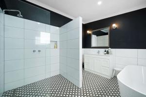 a bathroom with a shower and a sink and a toilet at The Old Guide Hall in Allansford +20 photos