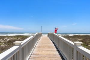a wooden boardwalk leading to the ocean on a beach at Gulf View Beach Home with Pool in Gulf Shores