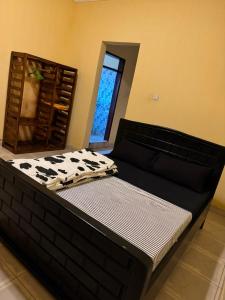 a large bed in a room with a cow print mattress at Binga villa in Kisoro