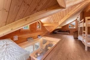 an overhead view of a bedroom and living room in a log cabin at Les chalets Super Geants in Saint-François-Longchamp