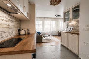 a kitchen with a sink and a living room at Bright & Spacious Apartment near Paris 6 Guests in Clichy +10 photos