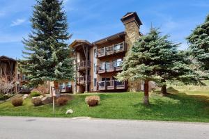 a large building with trees in front of it at Après Ski Hideaway, Unit 30A in Snowmass