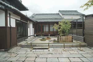 a house with a garden in front of a building at TOKIWA葛城-katsuragi- in Shinjō