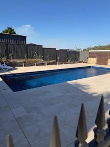 a swimming pool in front of a fence at Barooga River Gums Motor Inn in Barooga