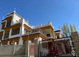 a large house with a gate in front of it at Rongmo villa in Leh
