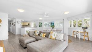 a living room with a couch and a table at The Entrance Unit 5 in Kawana Waters