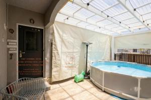 a large hot tub in a building with a large window at Sea & Desert Retreat in Arad