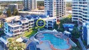 an aerial view of a swimming pool in a city at Grand Pacific Unit 19 in Caloundra