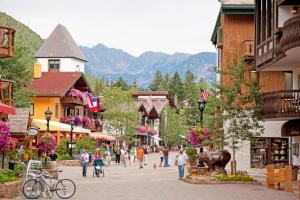 a group of people walking down a street in a town at Vail International 204 in Vail