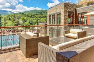 a balcony with chairs and a view of a pool at Riverfront Escape #320 in Avon