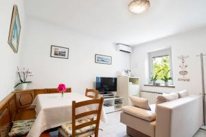 a living room with a table and a couch at Apartment Gorgo in Sečovlje