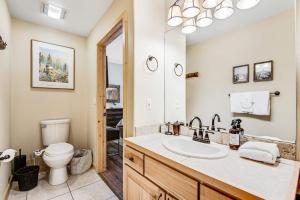 a bathroom with a sink and a toilet at Take A Break In Breck in Breckenridge +40 photos